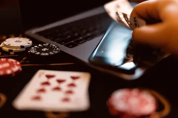 09DET Slots — Thousands of thrilling machines await A woman smiling by bright slot machines showing lucky symbols, showcasing the exciting slot offerings at 09DET.